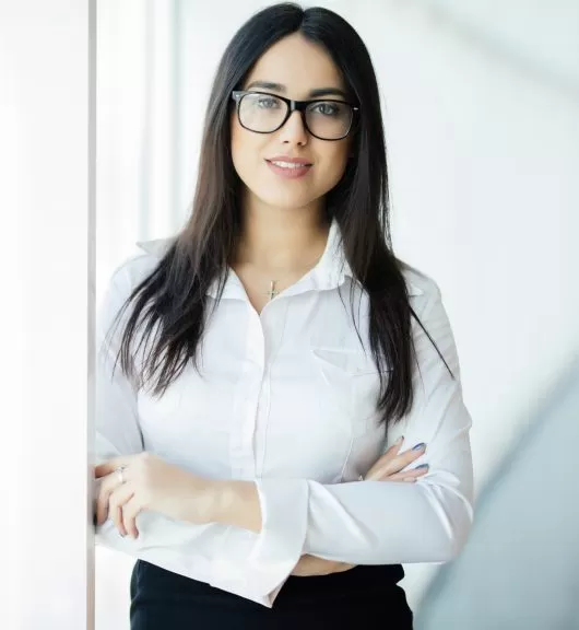 Businesswoman crossed hands portrait in office with panoramic windows.